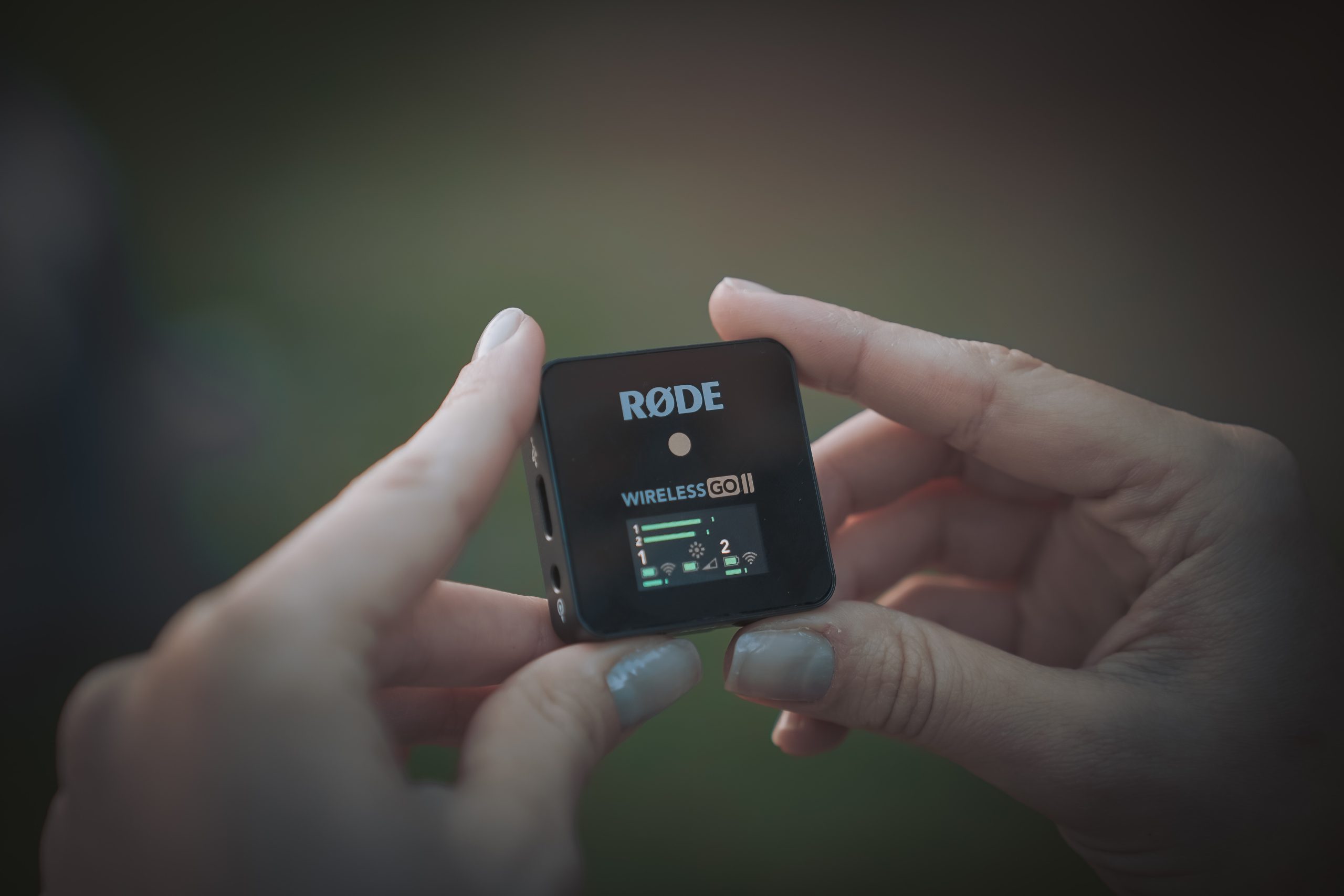 Young woman holding Rode Wireless Go II