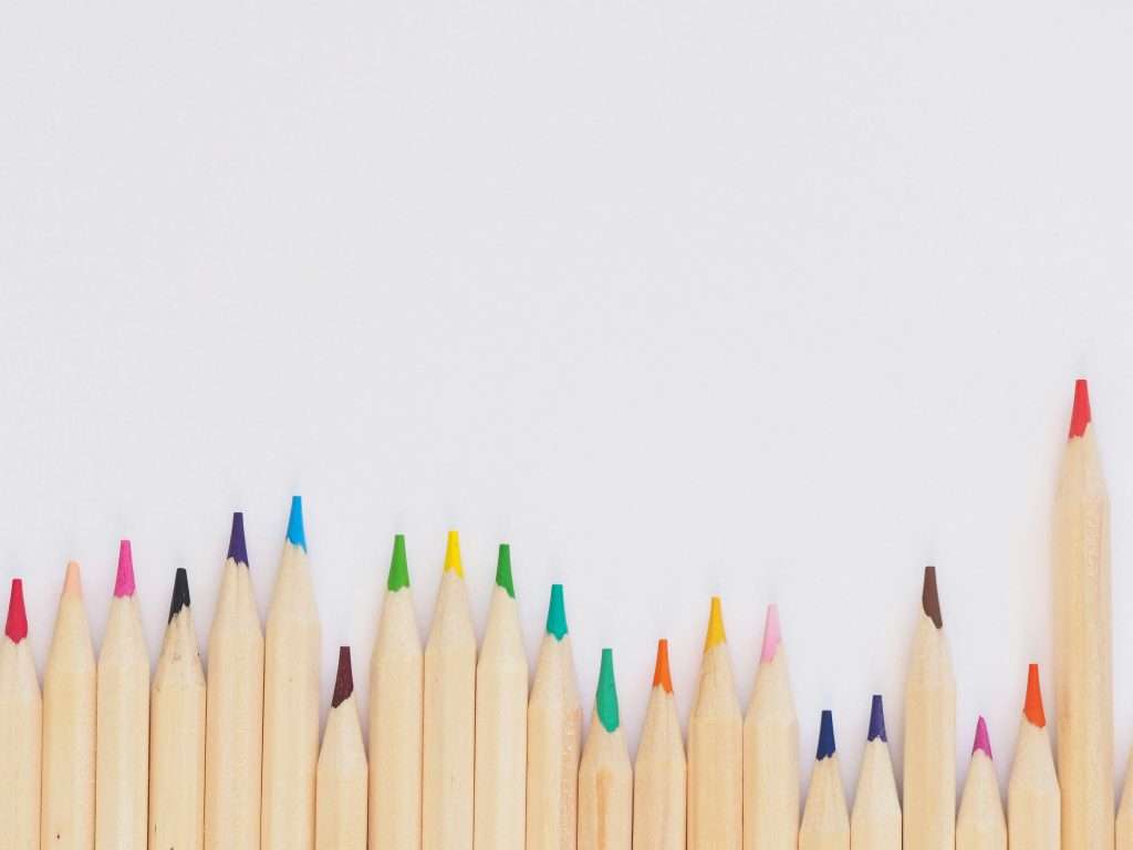 A set of coloured pencils, photo by Jess Bailey from Unsplash.