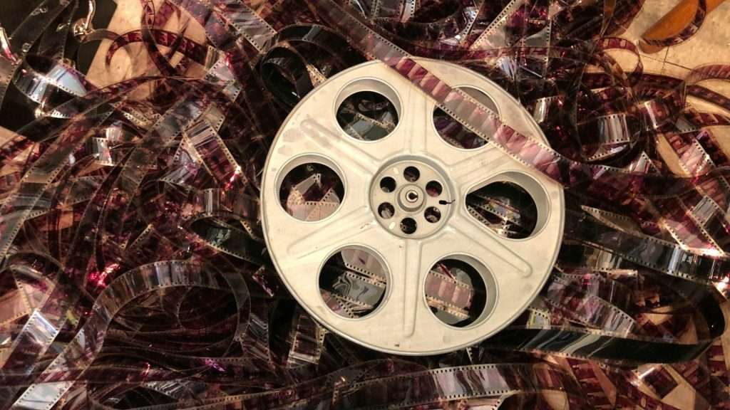 Vintage industrial film reel with all of the old film around it.